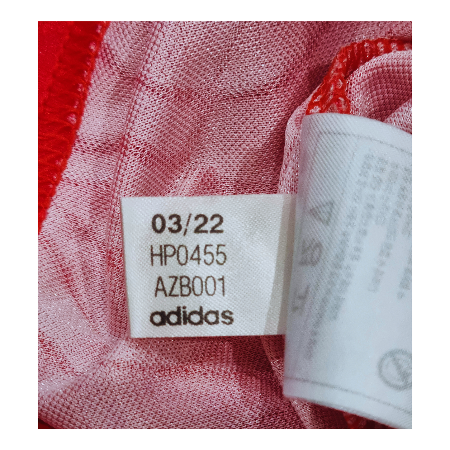 An Adidas Manchester United 1991/92 Home Jersey Re-release with a red and white label.