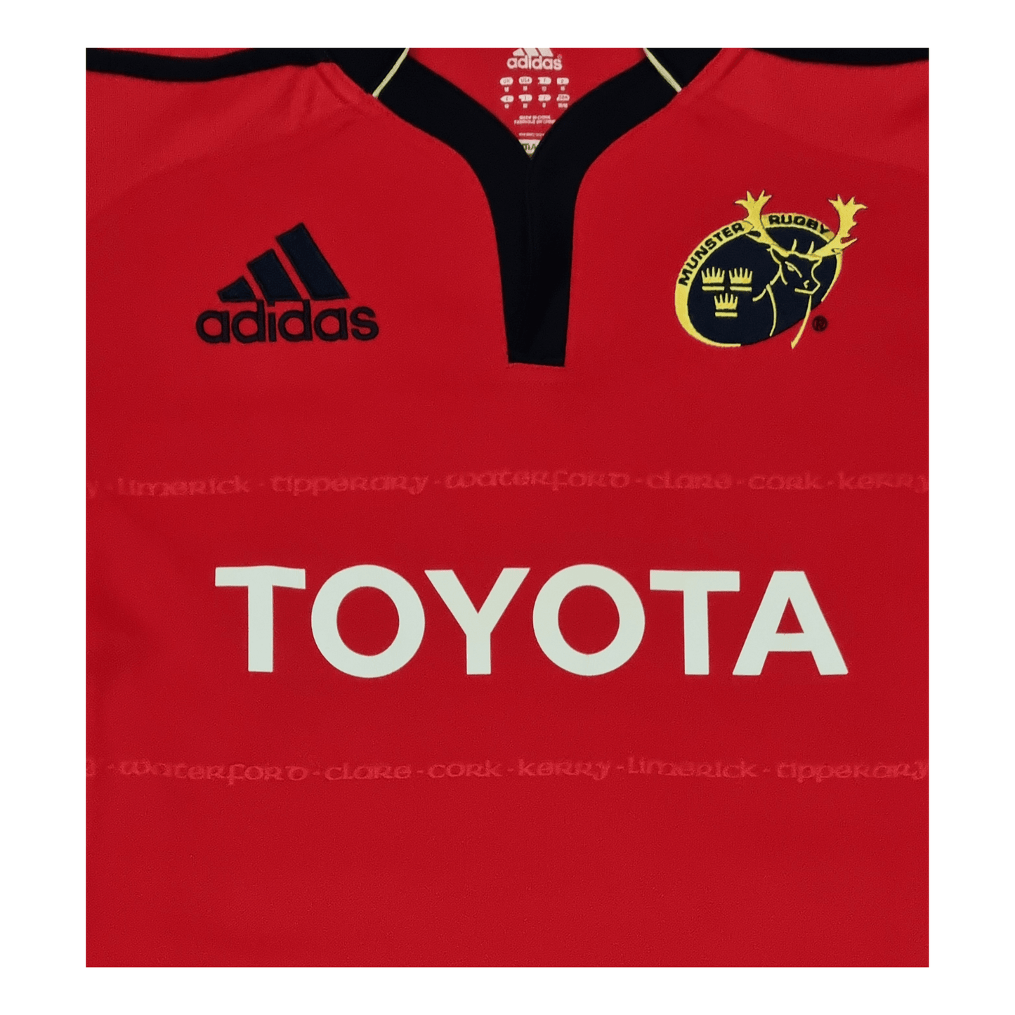 A red Adidas Munster 2011/12 Home Jersey with the words Toyota on it.