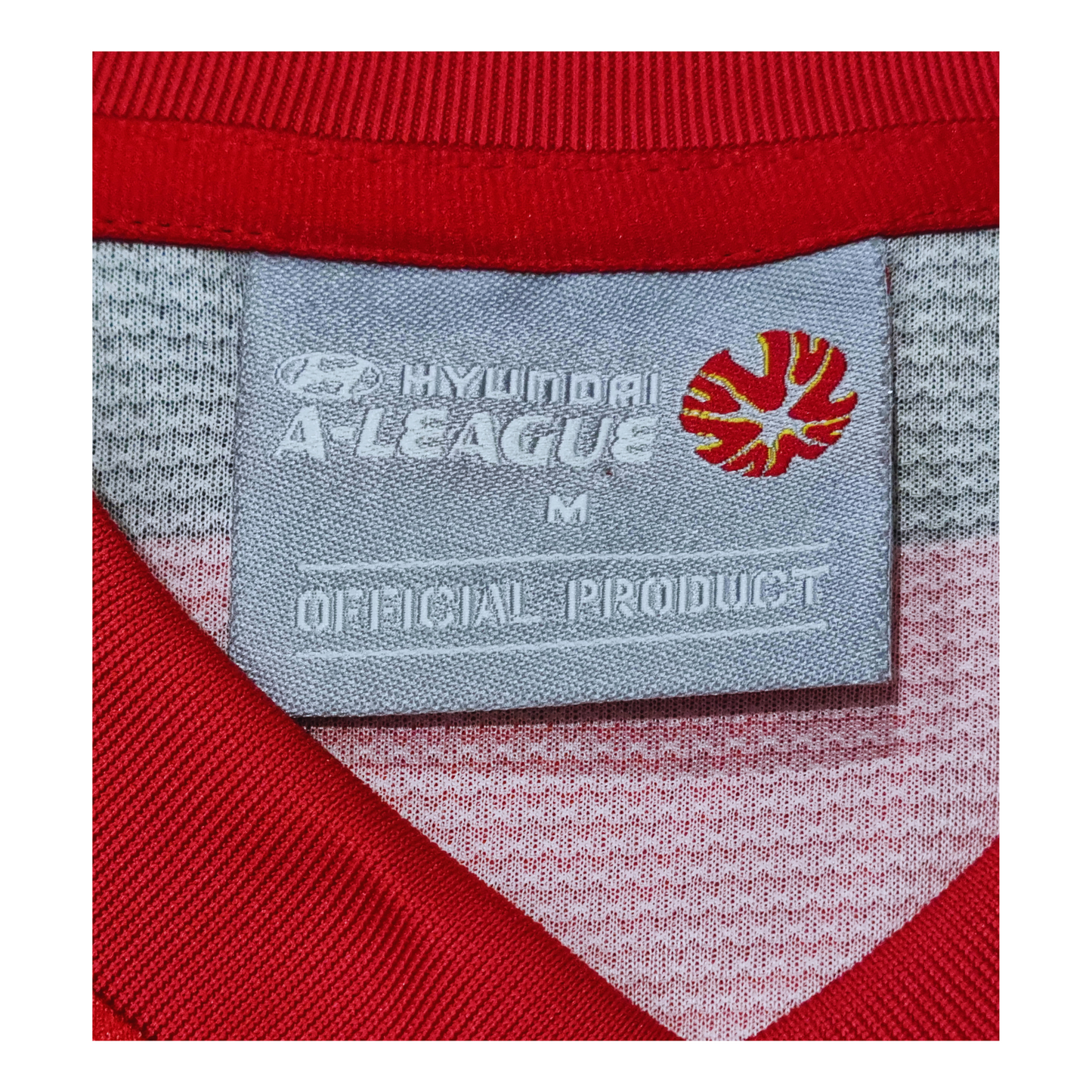 A red shirt with a label that says Western Sydney Wanderers 2013/14 Home Jersey by Nike.