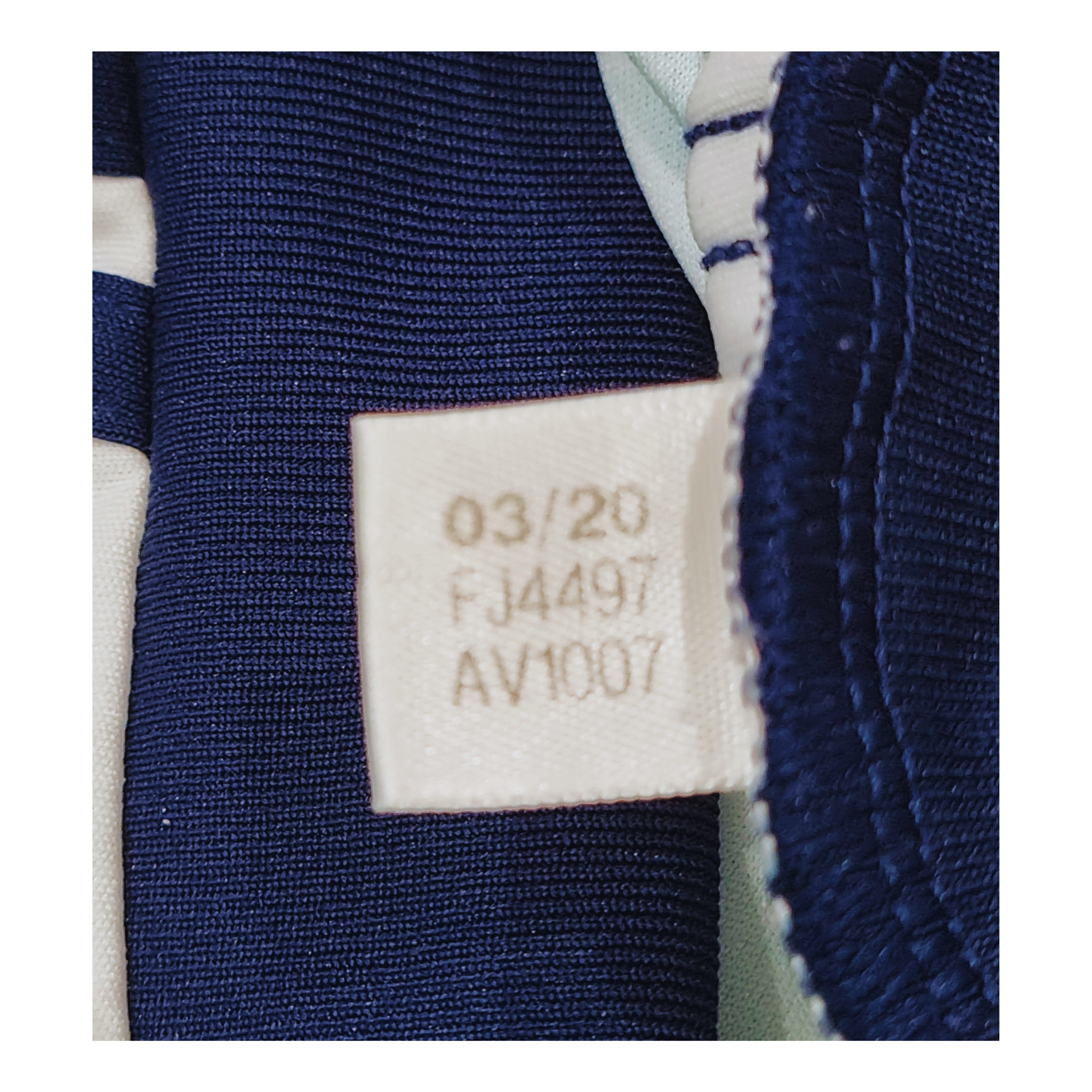 A close up of a blue and white label on an Adidas Wolverhampton Wanderers 2020/21 Away Jersey.