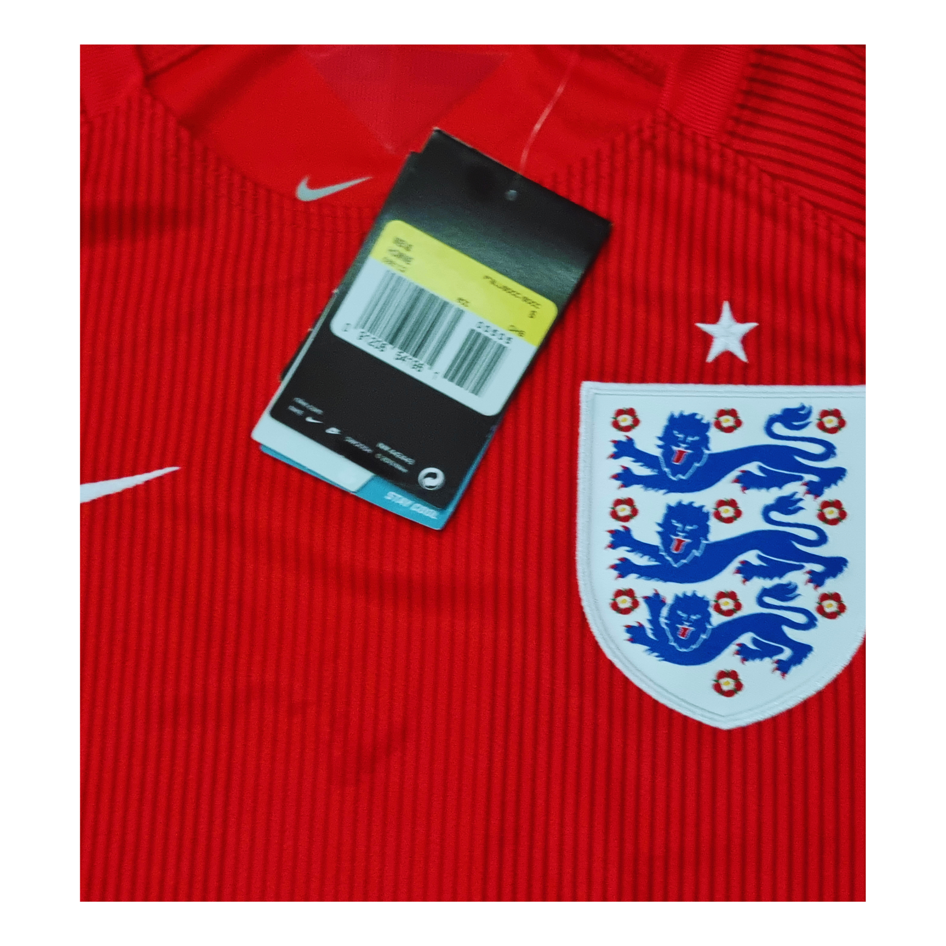 Nike's England 2014 Away Jersey with a tag on it, available in Small and Medium sizes.